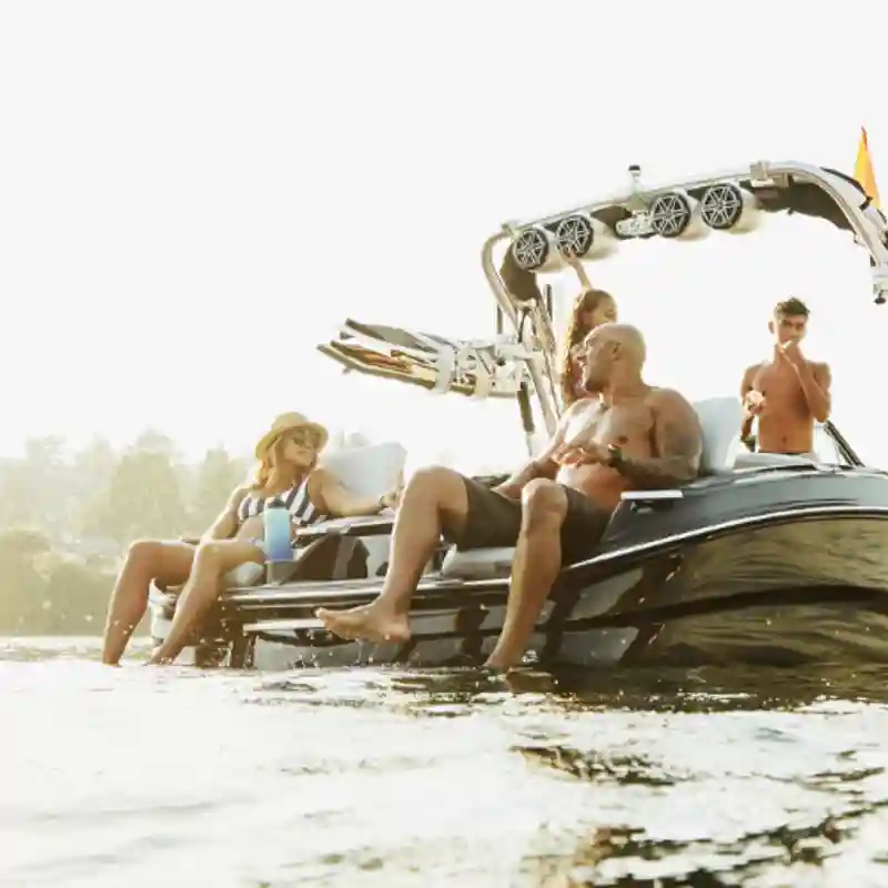 people sitting on a boat in the middle of a lake