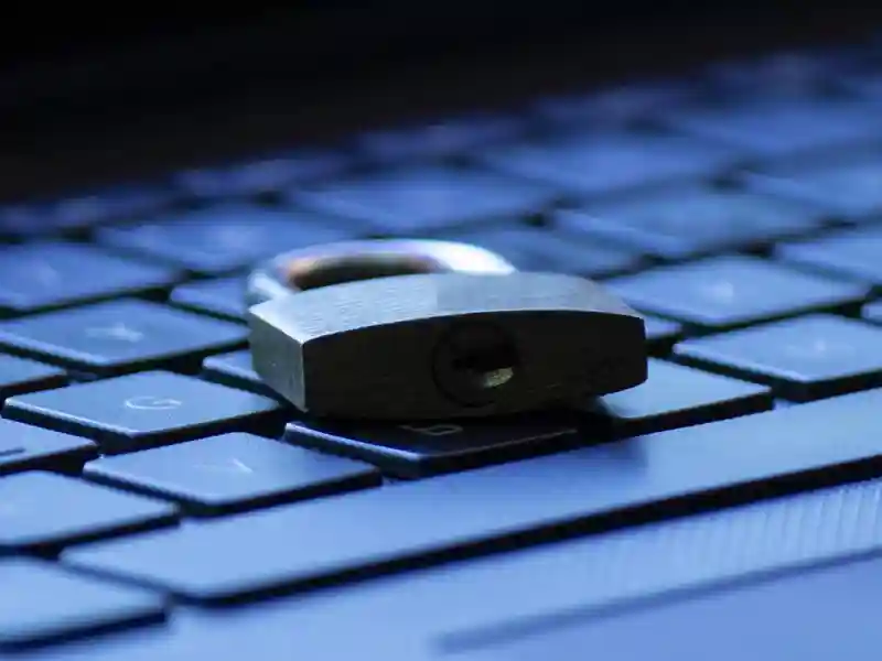 A padlock sits on a computer keyboard