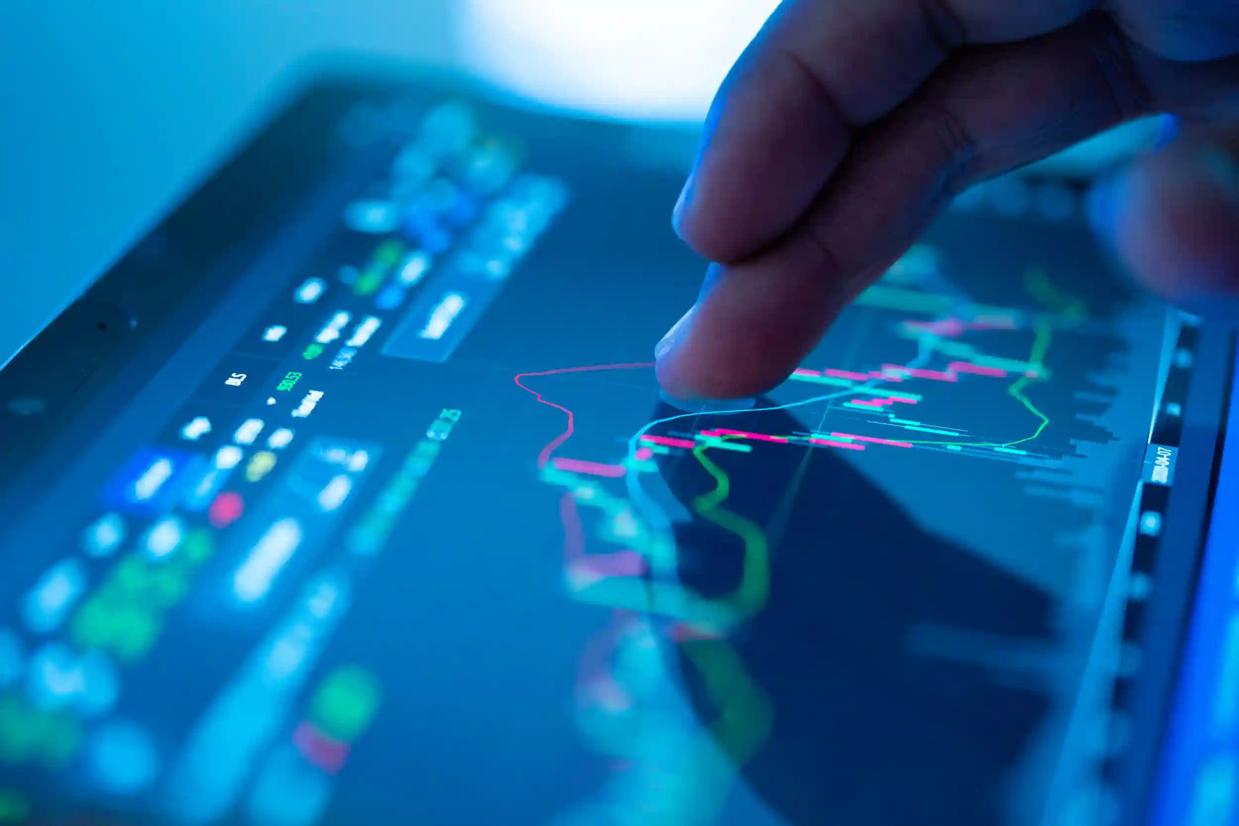 Close up of a finger on a tablet touching a graph.