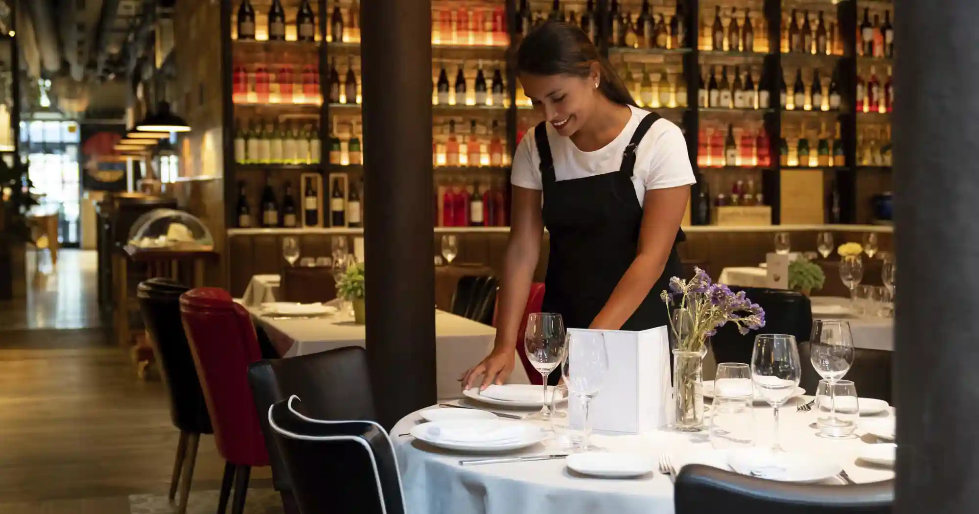 waitress setting out plates on a table