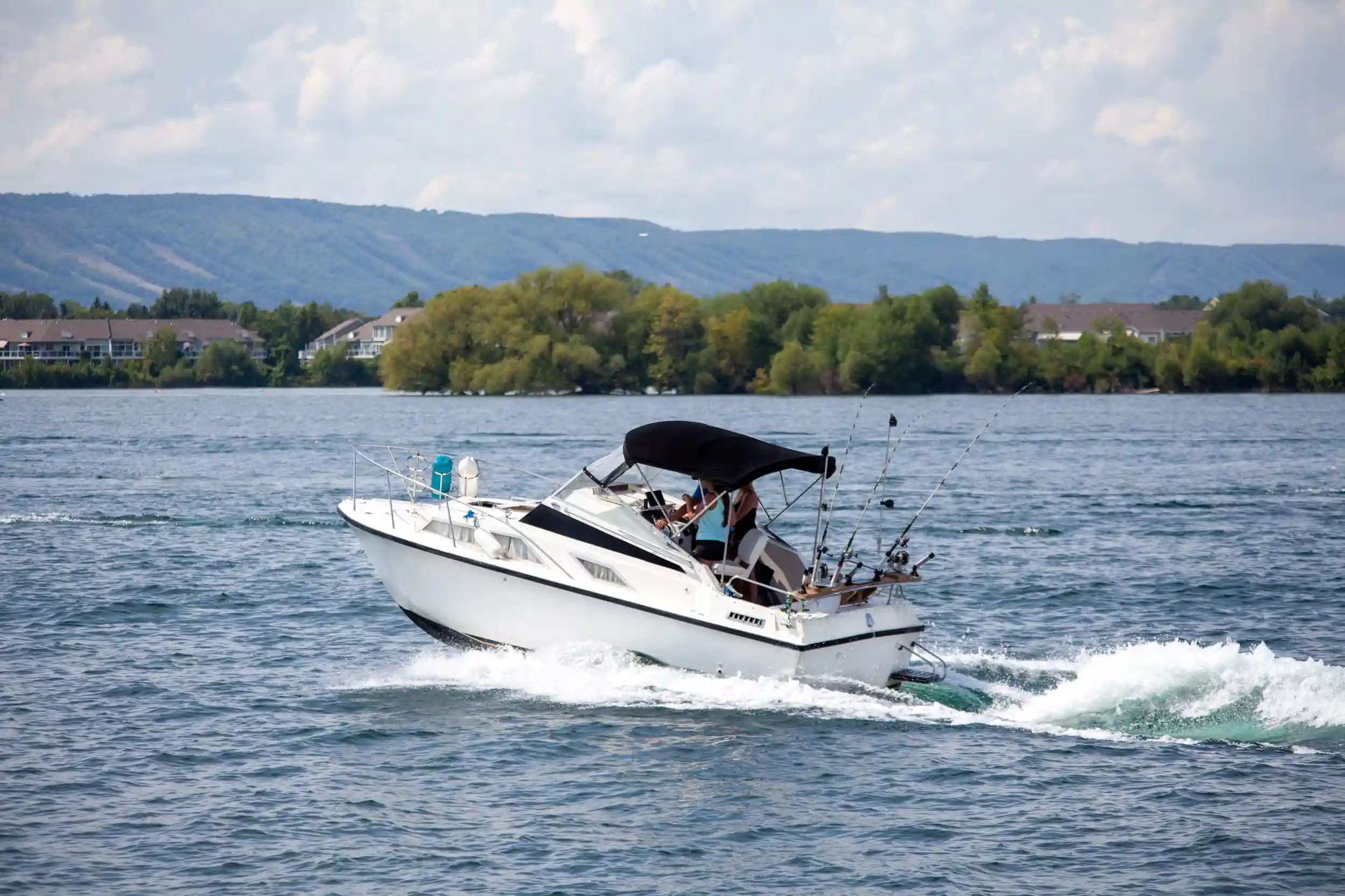 A boat going along a large inland lake.