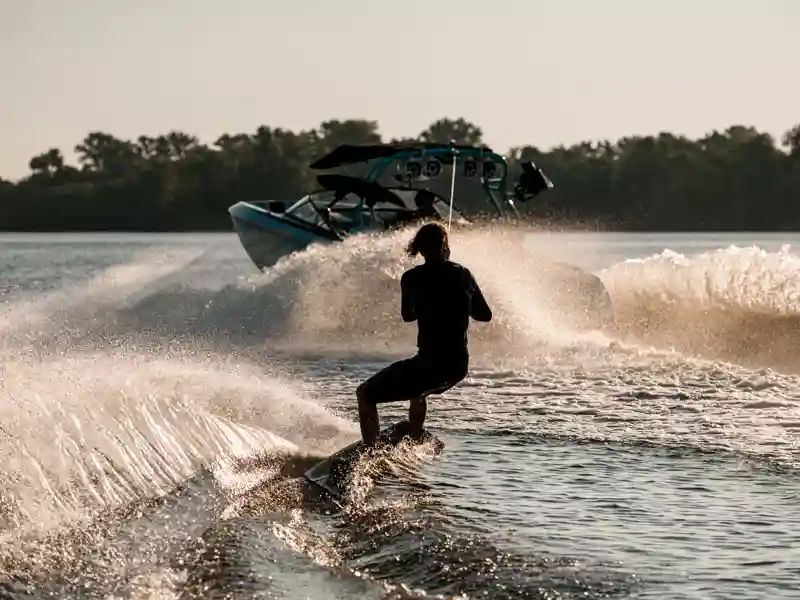 Skier being pulled behind a boat.
