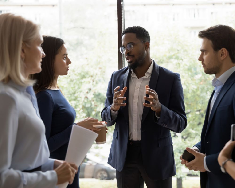 Four people standing and talking