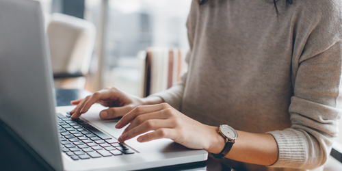 A woman sitting at a computer typing