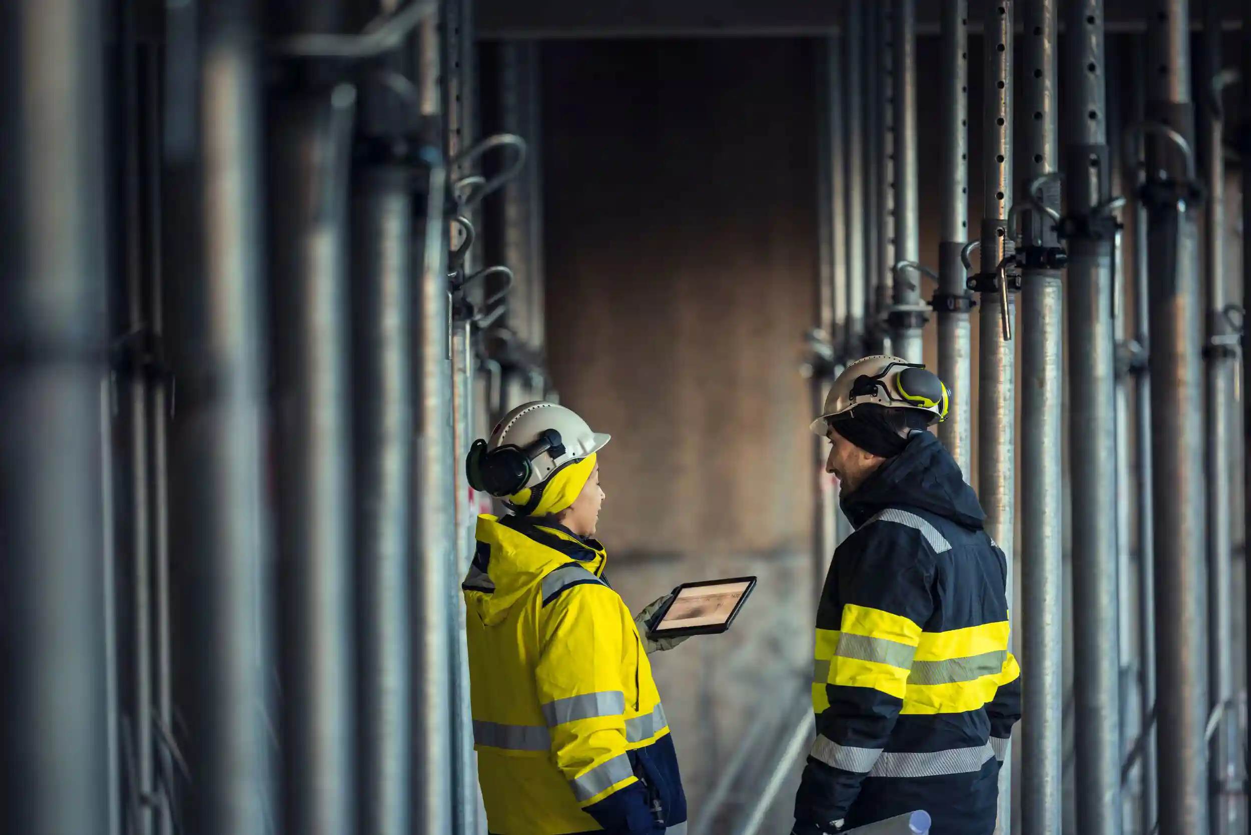 Engineers talking at building site.