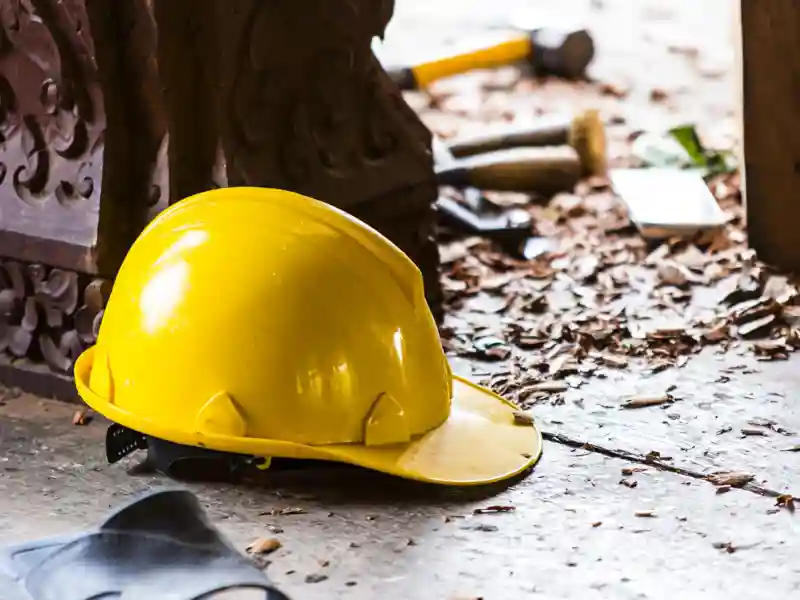 Hard hat on the construction site on the background.
