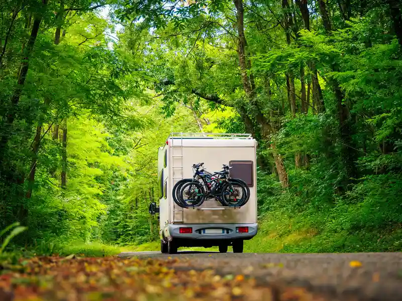 A recreational vehicle travels down a country road.