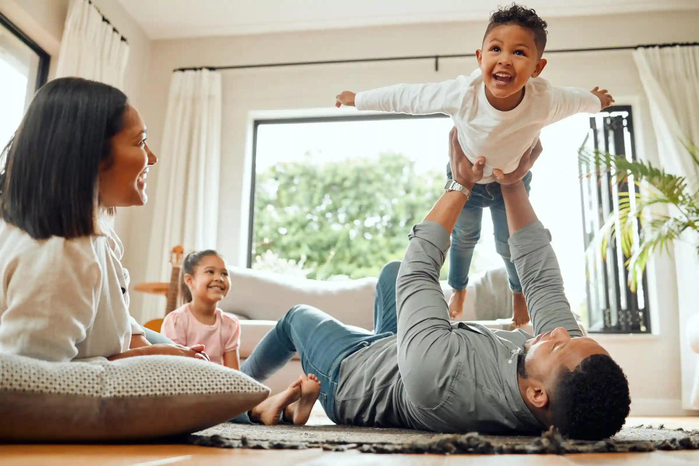 A family enjoys playing with their young child