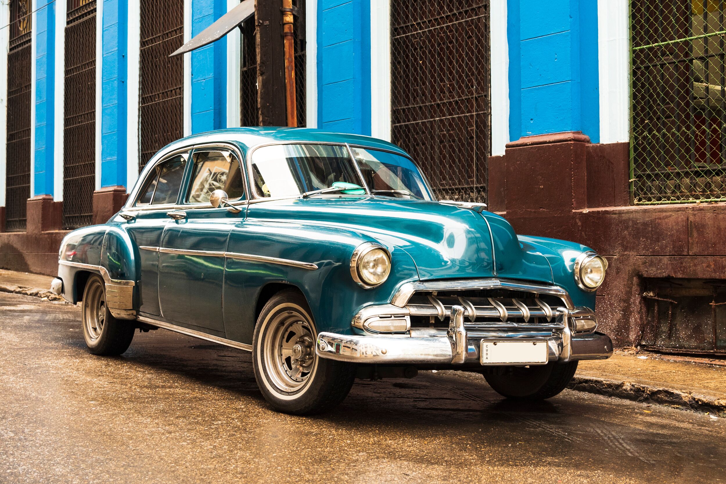 Old blue vintage classic American car in the street.